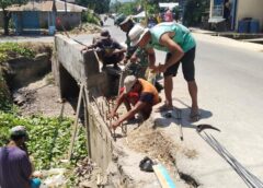 Babinsa 1513-01/Piru dan Warga Perbaiki Talut Jembatan KM 1 Piru, Antisipasi Longsor Dan Bahaya Banjir